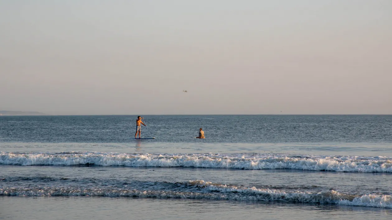 Paddle Boarder and Surfer at Dog Run Beach