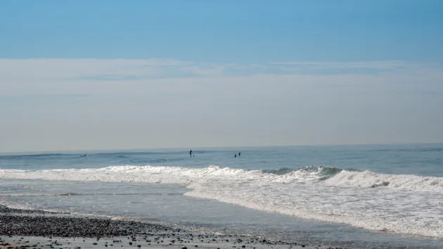 Paddle Boarder and Surfer Waiting for Waves at Boneyards