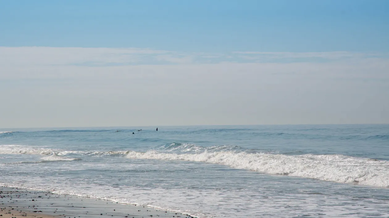 A Couple Surfers in the Lineup at Boneyards