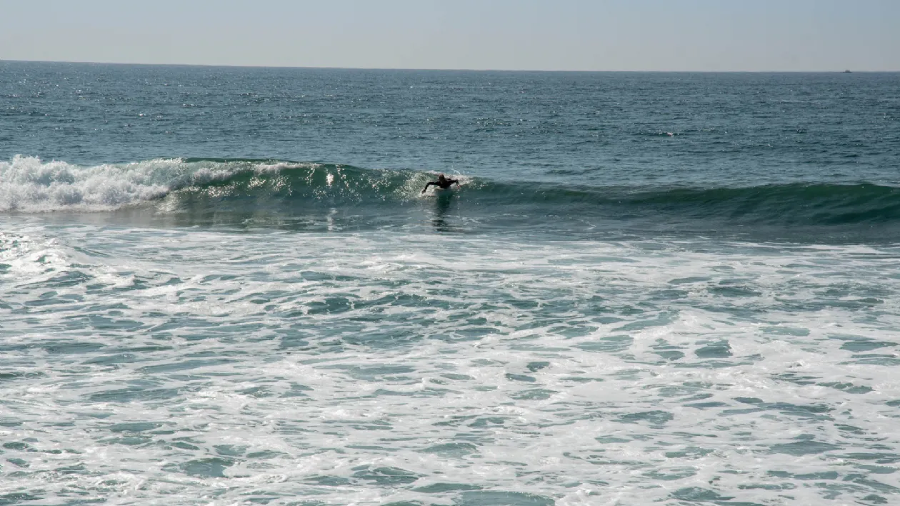 Surfer Catching a Small Wave at Buccaneer Beach