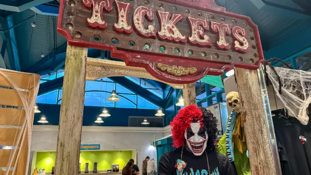 Creapy Clown in Ticket Booth at Howl O Scream Sign at Seaworld San Diego